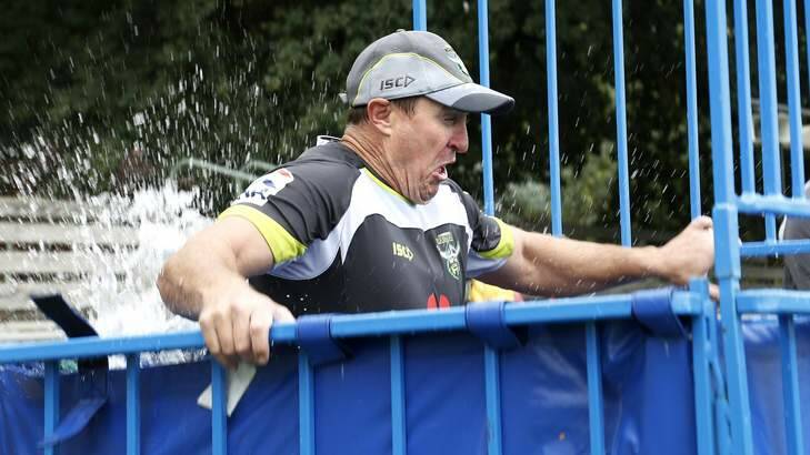 Canberra Raiders coach David Furner drops into the dunk tank. Photo: Jeffrey Chan