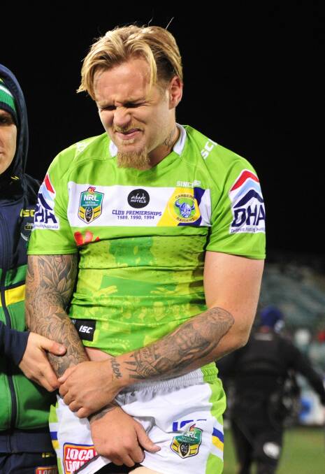Blake Austin leaves the field on Monday after injuring his shoulder. Photo: Melissa Adams 