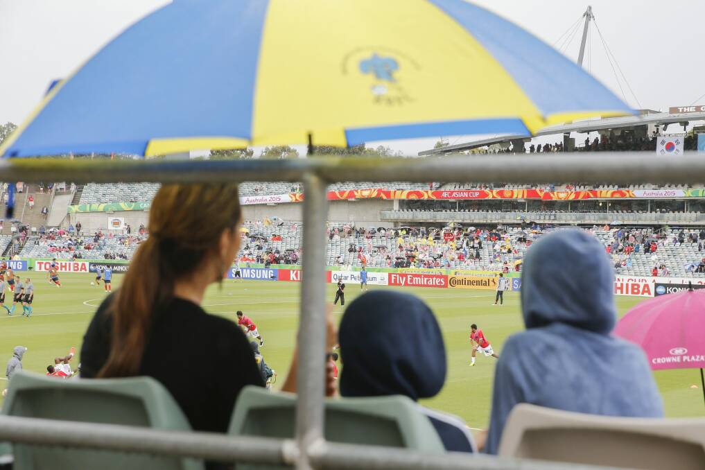 Rain didn't deter the crowd at the Asian Cup football matches in Canberra. Photo: Matt Bedford