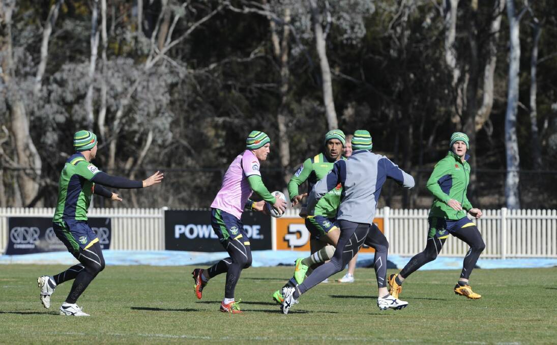 Raiders players trained in beanies and compression clothing on Wednesday to get used to the Townsville climate. Photo: Graham Tidy
