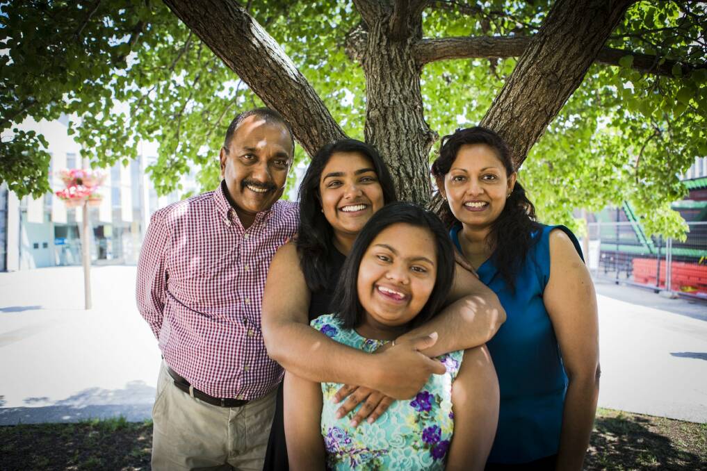 2014 Young Canberra Citizen of the Year Nipuni Wijewickrema, hugging her 15-year-old sister Gayana, and with her proud dad Ranjith, and stepmother Geetha. Photo: Jamila Toderas