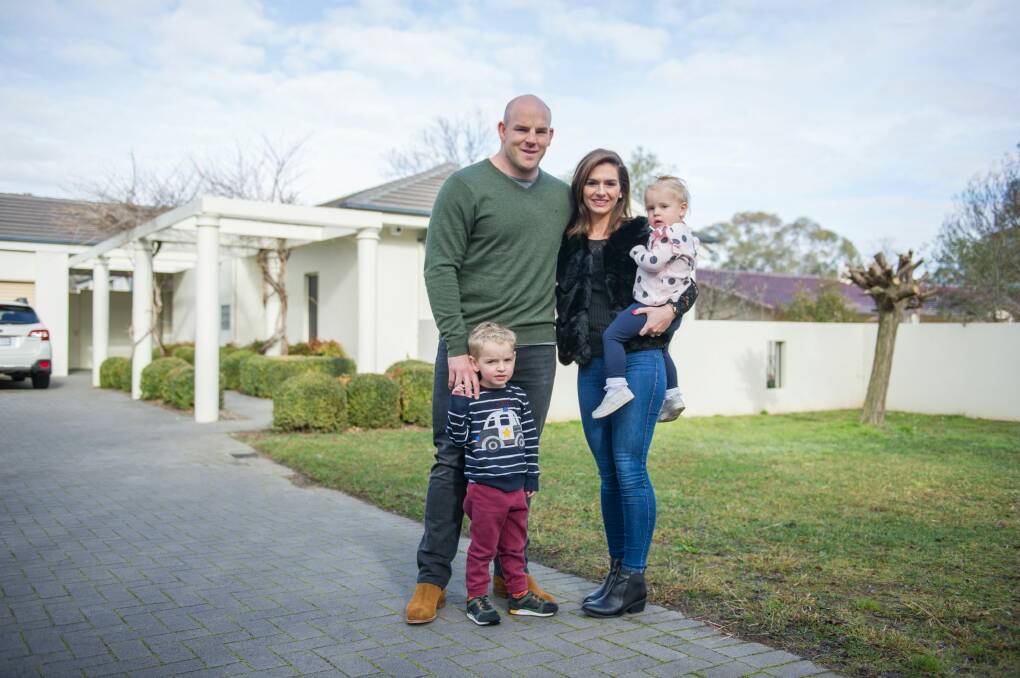 Stephen, Courtney, Theodore and Darcy Moore outside their Canberra home in Yarralumla. Photo: Jay Cronan