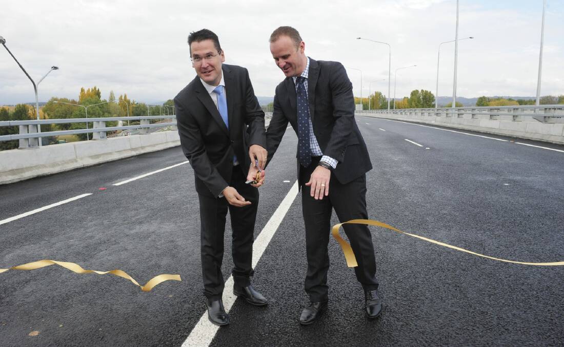 At the official opening of the Malcolm Fraser Bridge, part of the Majura Parkway project, Senator Zed Seselja, left, and ACT Chief Minister Andrew Barr cut the ribbon. Photo: Graham Tidy