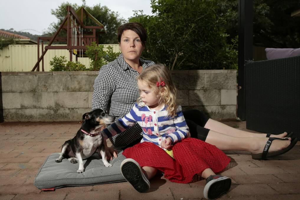 Renee Dean and daughter Chloe McGregor, 3, with their rescue dog, Poppy. The family's two dogs were mauled in an attack in 2014.  Photo: Jeffrey Chan