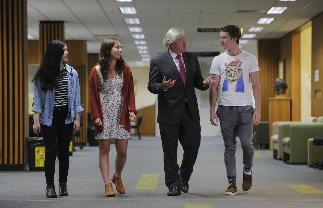 Newly appointed vice-chancellor Professor Brian Schmidt meets new ANU students, from left, Hannah Chan, Therese McMahon and Callum Sambridge. Photo: Graham Tidy