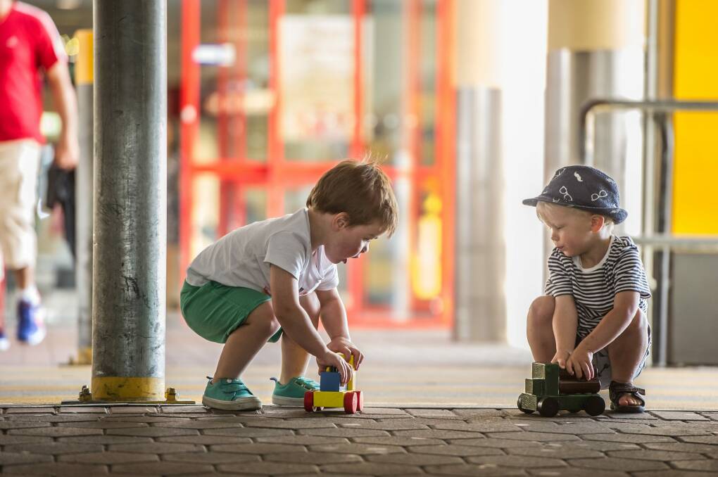 Two-year-olds Oliver Dawson and Louis Kane quickly made use of their wooden toys. Photo: Karleen Minney