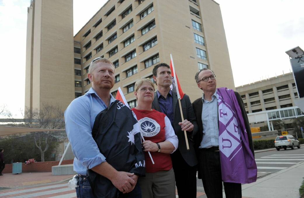 Jenny Miragaya (second from left), with other union representatives Dean Hall (CFMEU), Glenn Fowler (AEU) and Stephen Darwin (NTEU) outside Canberra Hospital.  Photo: Graham Tidy GGT