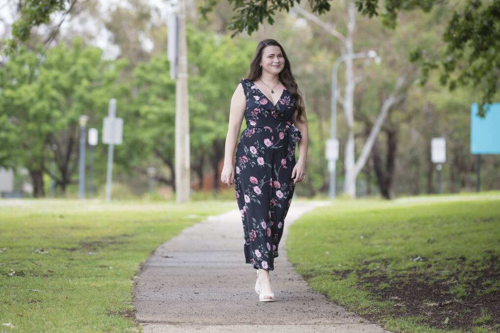 Australian National University graduand Georgia Wilson, pictured at the university on Thursday, had to learn how to walk again after a brain injury in May. Photo: Sitthixay Ditthavong