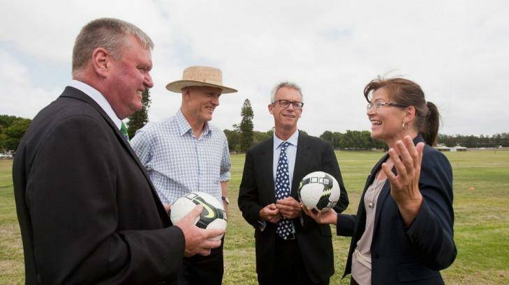 Michael Brown with then ministers Peter Garrett, Kate Lundy and FFA CEO David Gallop (second from right) talk at an Asian Cup promotional event in 2013. Photo: Getty Images