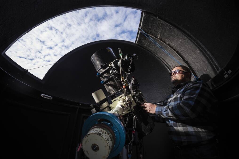 Michael Sidonio at Terroux Observatory, which houses a 30 centimetre telescope in the dome just outside of Canberra. Photo: Sitthixay Ditthavong