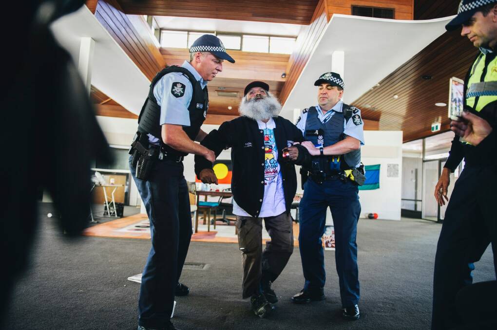 A man is arrested and removed from the old Lobby Restaurant. Photo: Rohan Thomson