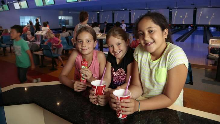 Emma Jackson 9, Chloe Turner 10 and Taila Foster - Wright 9 find relief from the heat in the air conditioning at AMF Bowling Tuggeranong. Photo: Jeffrey Chan
