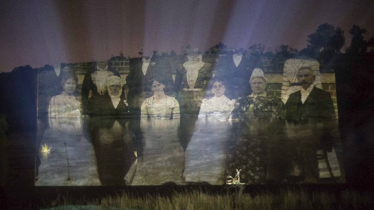 Photographs and paintings from the National Museum of Australia's collections are projected onto rolling fog and the waters of the Murrumbidgee River by artist-in-residence Vic McEwan and curator George Main. Ghostly faces of pioneers long past. Photo: National Museum of Australia 