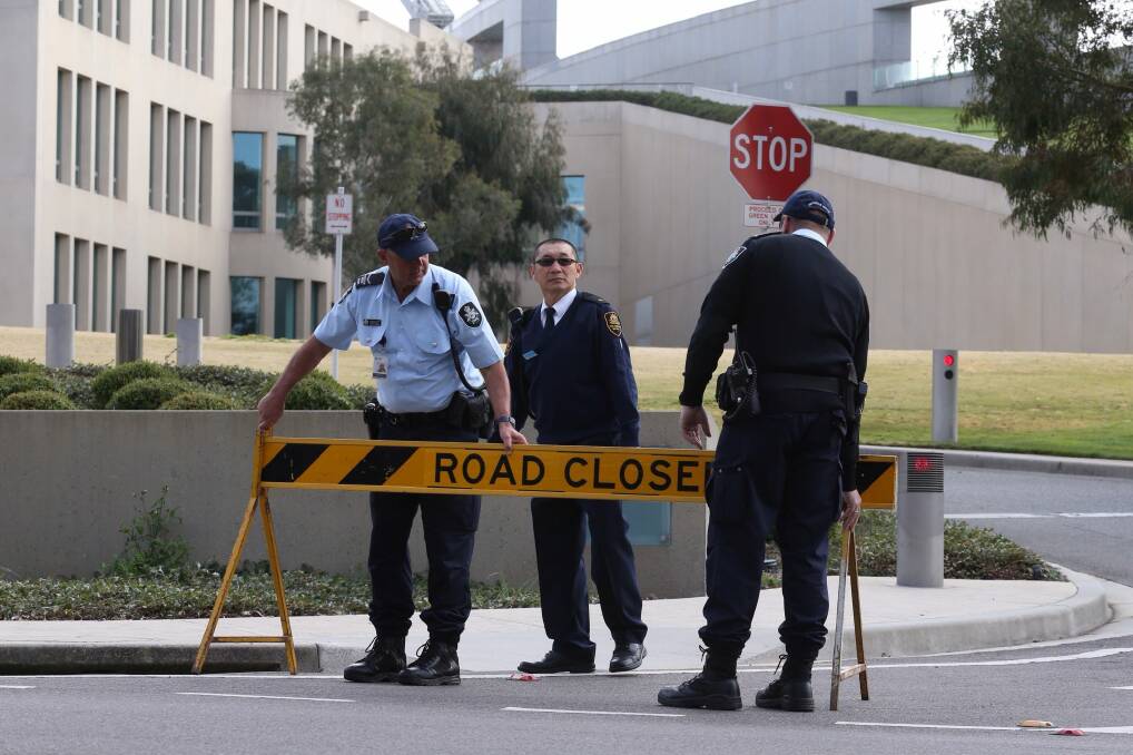 Australian Federal Police officers lockdown the ministerial entrance to Parliament House in Canberra after a security threat last September. Photo: Andrew Meares