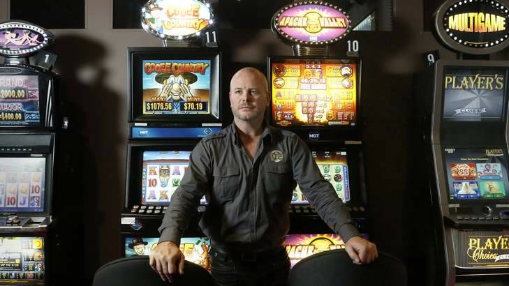 The RUC secretary manager Jeremy Wilcox with some of the poker machines at the club. Photo: Jeffrey Chan