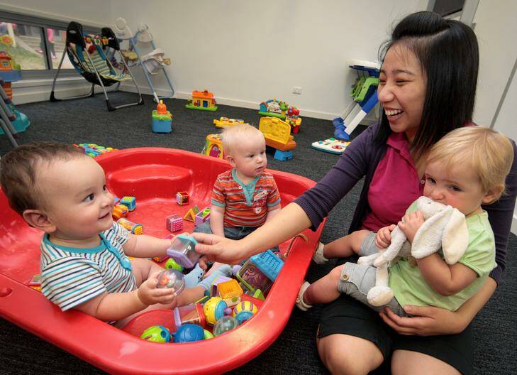 Samuel Bishop, 1 year, and Archer Hughes-Maher, 8 months, play with Betty Lam and Ruby Lendrum, 16 months, at the Baringa Child Care Centre. Photo: Jeffrey Chan