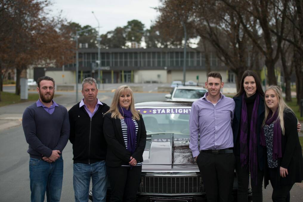 Kris Davis with his family and the restored car. Photo: Supplied
