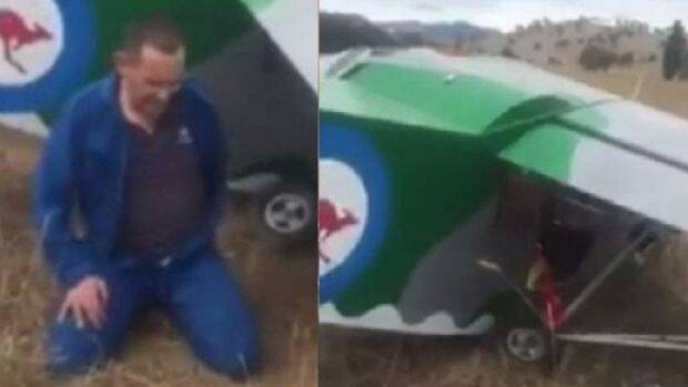 A man sits in shock after crash landing in a paddock, west of Canberra Photo: John Kingwell