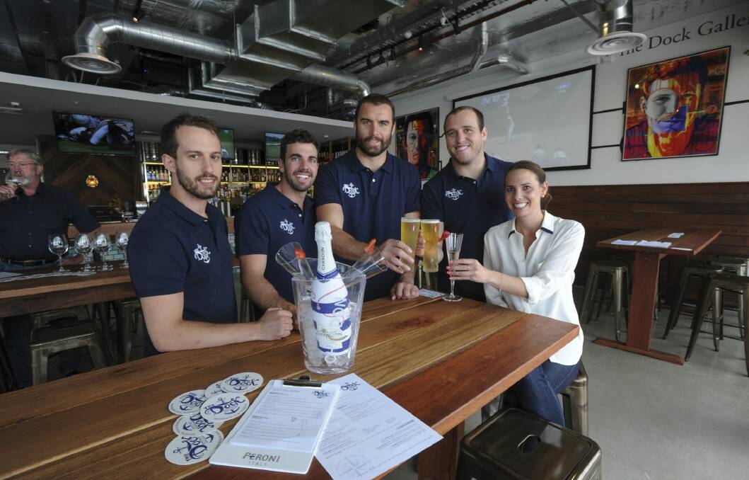 Business partners and Brumbies teammates, Scott Fardy, third from left, and Ben Alexander, fourth from left, with other The Dock bar at Kingston Foreshore partners (from left) Brendan Curtis-Cocks, Glen Collins and Jane Collins.  Photo: Graham Tidy