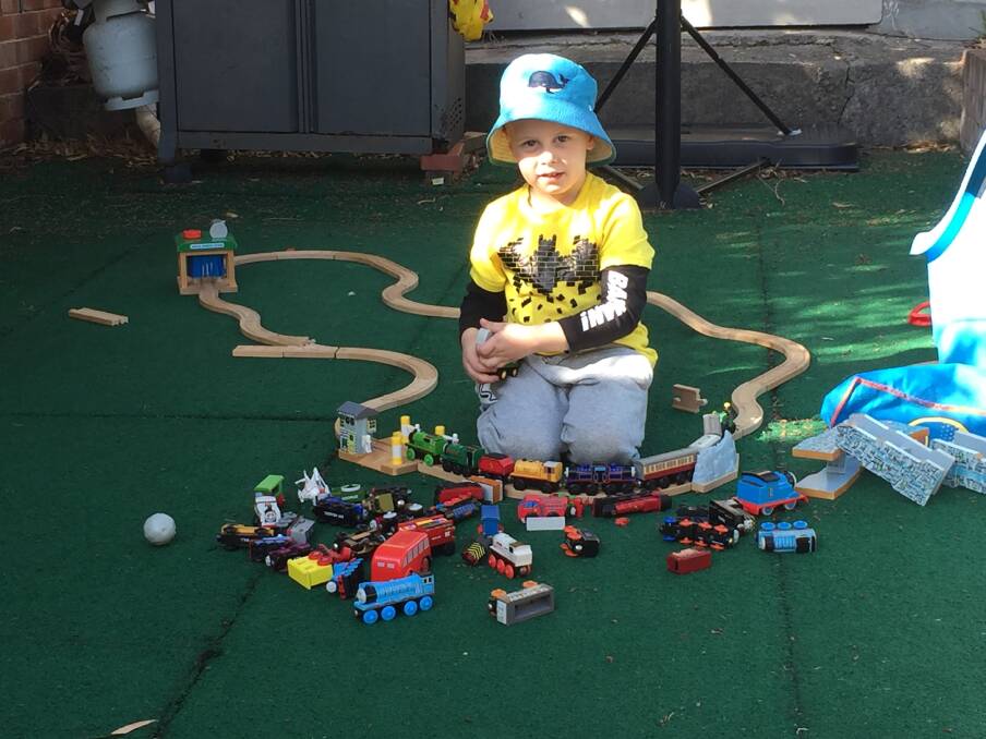 Blake Corney plays with his toy trains. The four-year-old died at the scene of a multi-vehicle crash on the Monaro Highway near Mugga Lane on July 28. Photo: Supplied