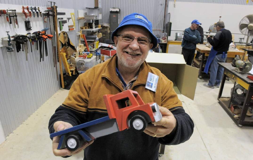 President Ian Paterson with a toy truck produced at the Tuggeranong men's shed.  Photo: Graham Tidy