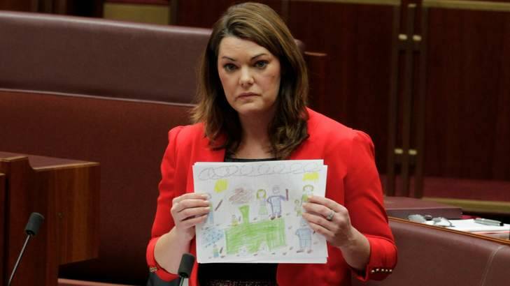Pictures of despair &#8230; Greens senator Sarah Hanson-Young with drawings done by some of the 38 children held with their families at Papua New Guinea's Manus Island processing centre. Photo: Andrew Meares