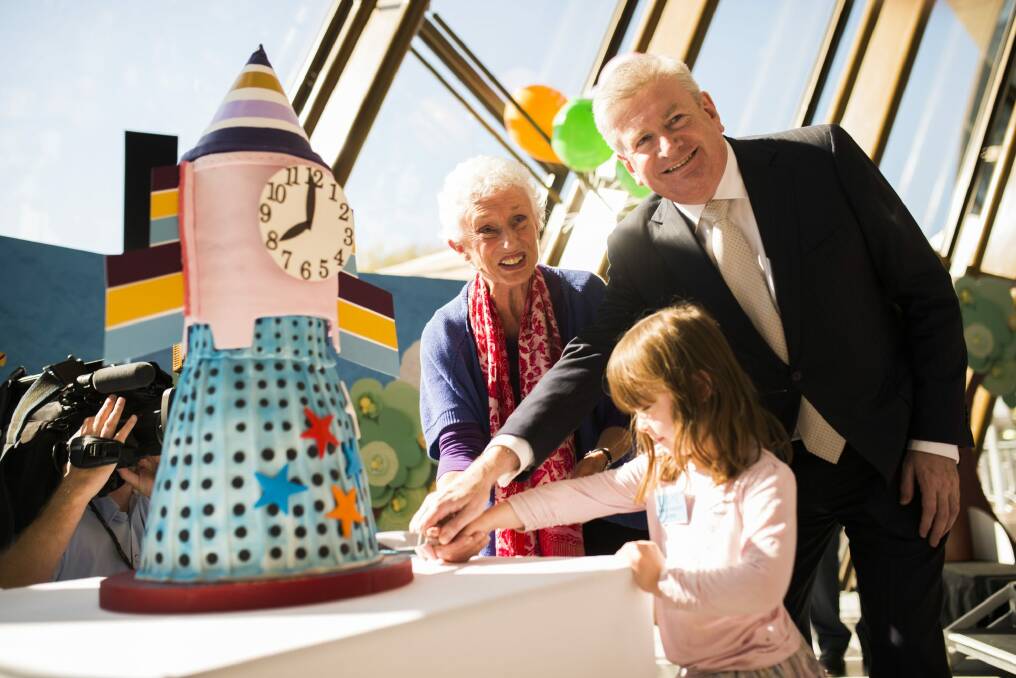 Cutting the Rocket Clock cake at the launch of the exhibition. Photo: Rohan Thomson