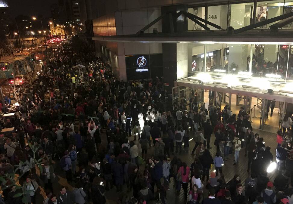 People evacuate a mall in Santiago after a powerful earthquake, in Santiago, Chile. Photo: AP