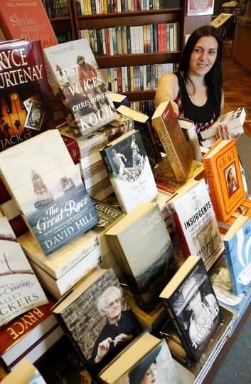 Paperchain Bookstore Manuka senior staff member Rose Ward restocks some of the Christmas best sellers. Photo: Jeffrey Chan
