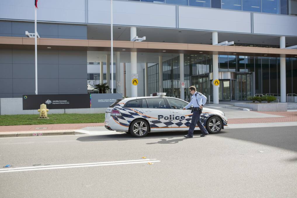 Police outside the Louisa Lawson Building in Tuggeranong on Wednesday morning. Photo: Jamila Toderas