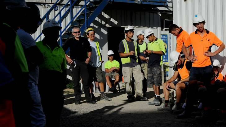 Norman MacLachlan, ACT construction manager for Project Coordination (black shirt) stands with his workers  from the Aurora apartments this morning. Photo: Colleen Petch