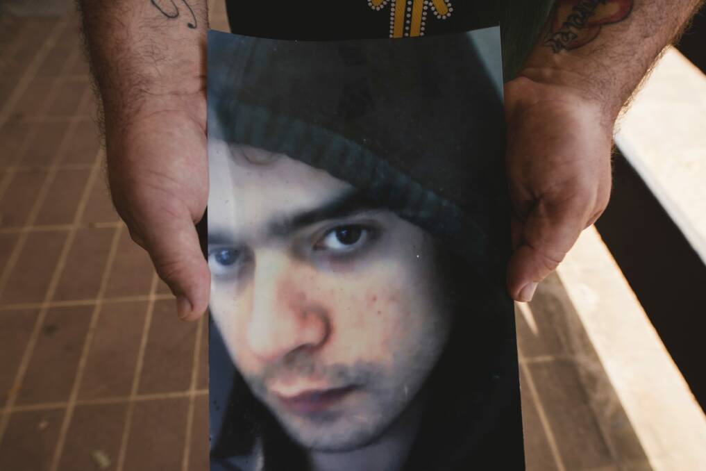 Matt Hogan holds a photo of his son Jonathon, who died at Junee prison in February. Photo: Jamila Toderas