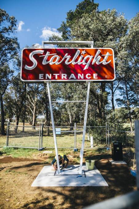 Workers put the final touches on the restored Starlight drive-in sign on Monday. Photo: Rohan Thomson