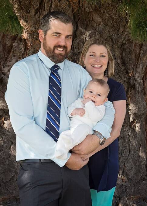 Kate Henderson with her husband Cody and her son Augustus at his christening in April. Photo: Kerry Beer Photography