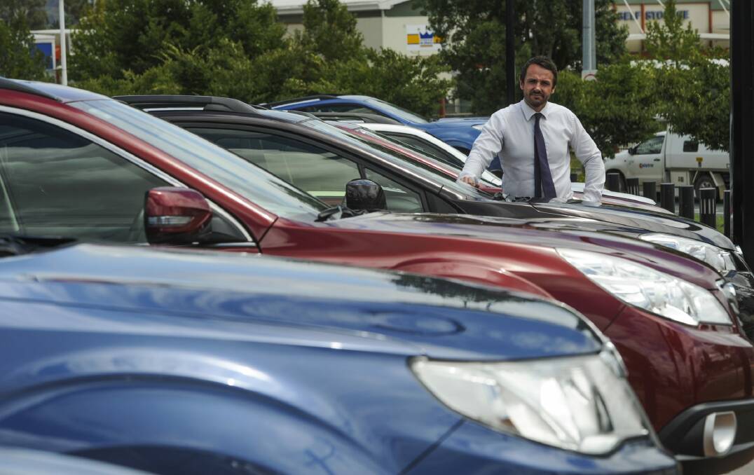 Hail on Saturday night caused damage to about 30 vehicles at the Capital Subaru dealership in Fyshwick. Dealer principal, Adam Clearihan, with some of the cars.
 Photo: Graham Tidy