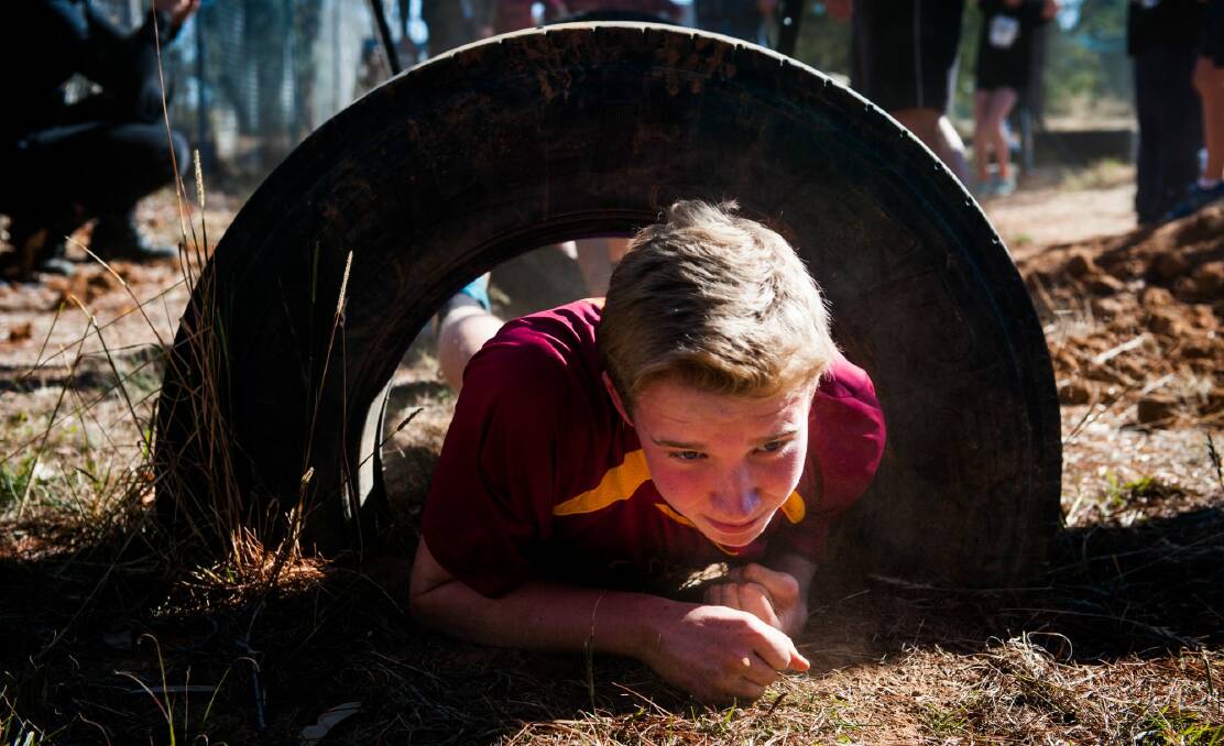 Campbell High School student Owen Hanna, 15, works his way through one of the big tyres. Photo: Elesa Kurtz