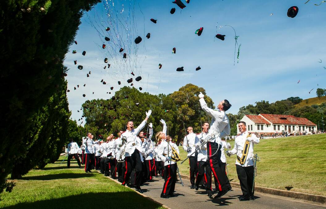 Graduates throw hats in the air at the Duntroon graduation ceremony. Photo: Elesa Kurtz