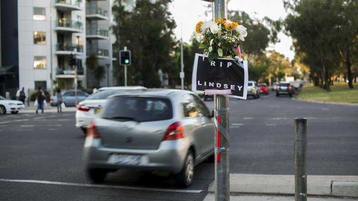 A sign and flowers at the intersection of Barry Dr and Northbourne Ave for well-known Canberra window-washer, Lindsay. Photo: Rohan Thomson