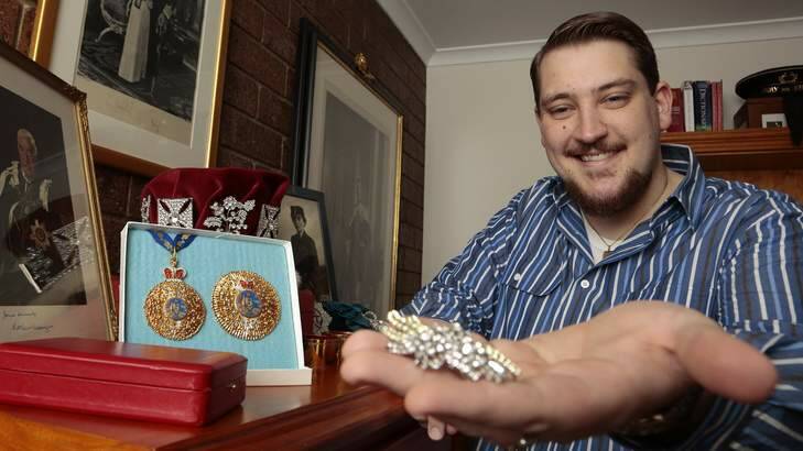 Scott Coleman from Waramanga with a replica of the Australian Wattle Brooch from his replica royal jewellery collection. Photo: Jeffrey Chan