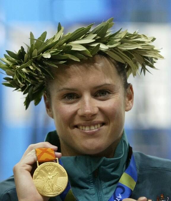 Olympic diver Chantelle Newbery shows off her gold medal in Athens in 2004. Photo: Reuters
