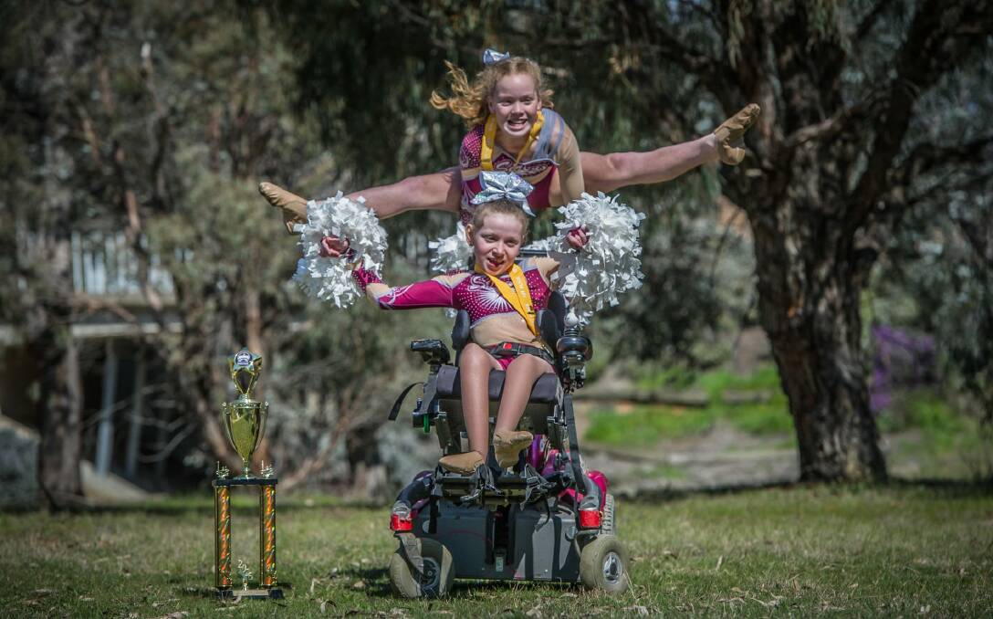 Bella Stokes (front) and Gaby Rooks (back) cheer with Sirens cheerleaders in Mitchell and are competing in the Australian All Star Cheerleading Federation nationals in November.  Photo: Karleen Minney