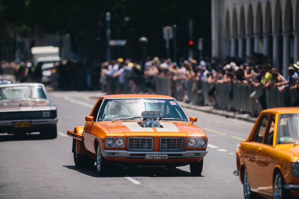 The crowd on Northbourne watches on as the Summernats City Cruise passes the Sydney Building. Photo: Rohan Thomson