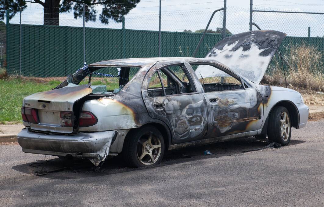The burnt out wreck of a car set on fire on Christmas Day on Narrabundah Lane, Symonston. Photo: Elesa Kurtz