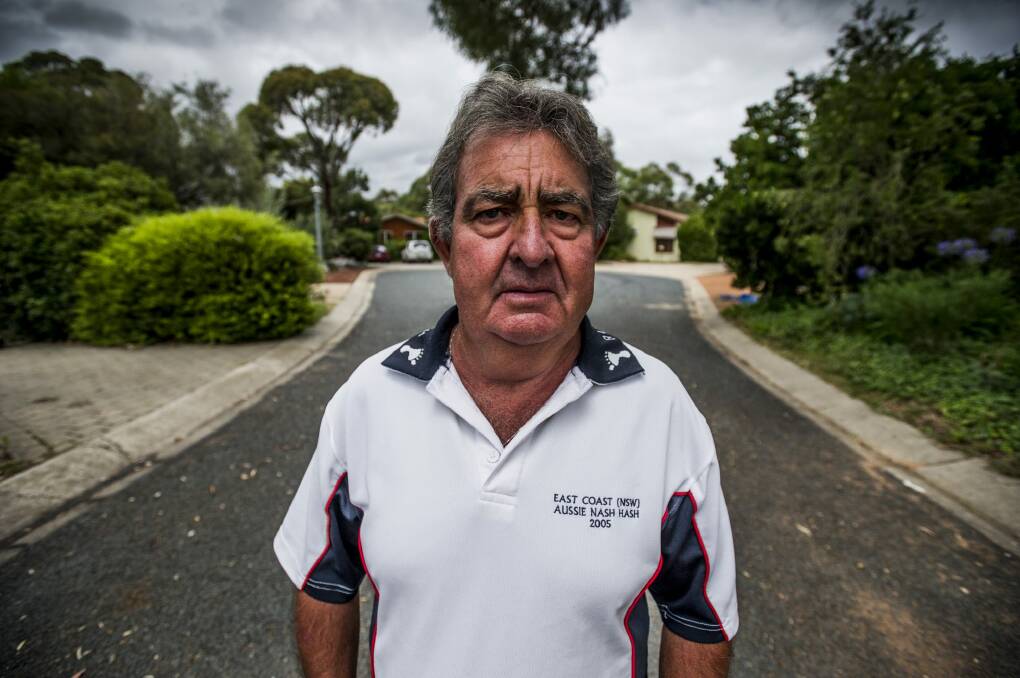 Resident Mick Farrelley stands in the quiet Kambah cul-de-sac where four of the nine houses contain Mr Fluffy asbestos. Photo: Jay Cronin