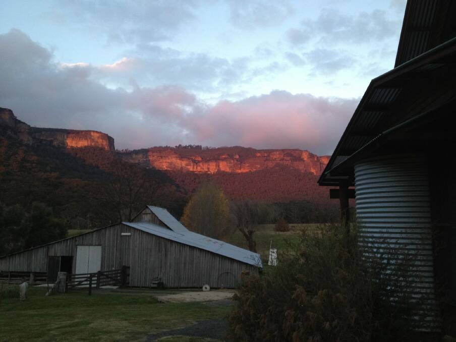 A fiery sunset seen  from the deck of Woolshed Cabins, looking over the historic woolshed  to the Kanimbla escarpment.  Photo: Marion Commens