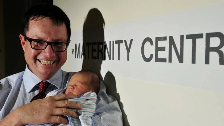 Prof Steven Robson with new born baby Daniel Keith Reynolds encouraging parents to conceive by first week of June to get full $5,000 baby bonus. Photo: Jay Cronan