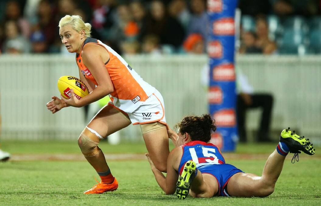 On the move: Renee Tomkins of the Giants is tackled by Meghan McDonald of the Bulldogs. Photo: Getty Images
