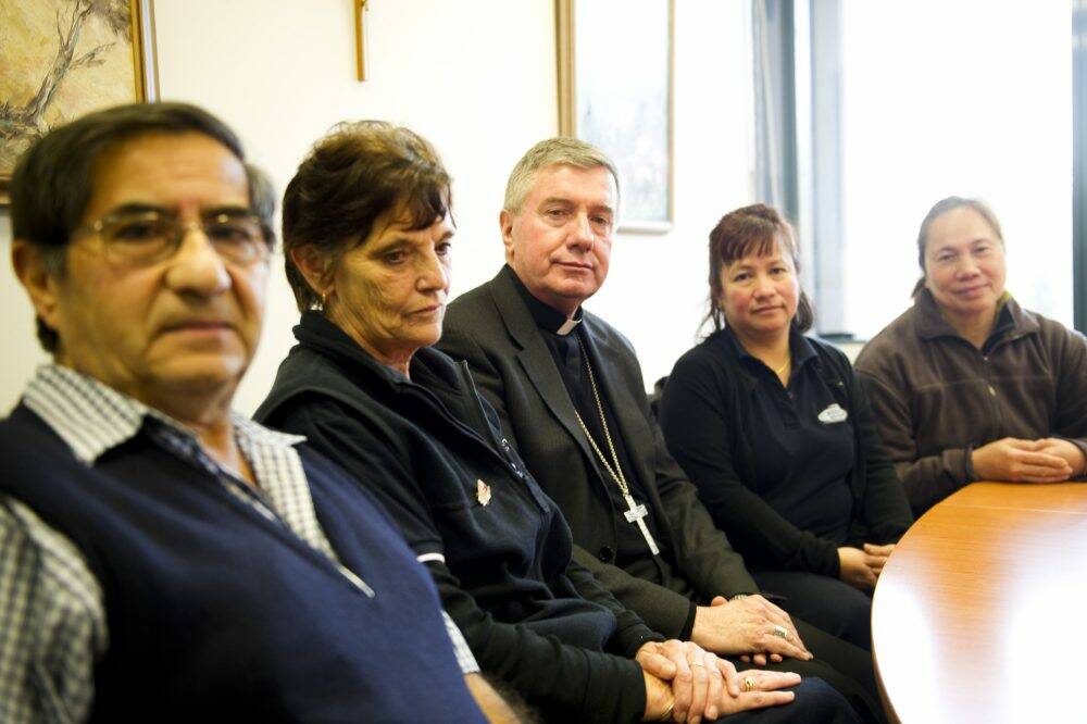 Cleaners (l-r) Carlos Pavez, Linda Morrison, Liza Grealy and Fe Anave Miles meet with Archbishop of Canberra and Gouldburn Most Rev Christopher Prowse (centre)  who has rejected the Coalition's moves to strip guidelines which could cost a full-time cleaner at least $185 a week.
Photo Jay Cronan