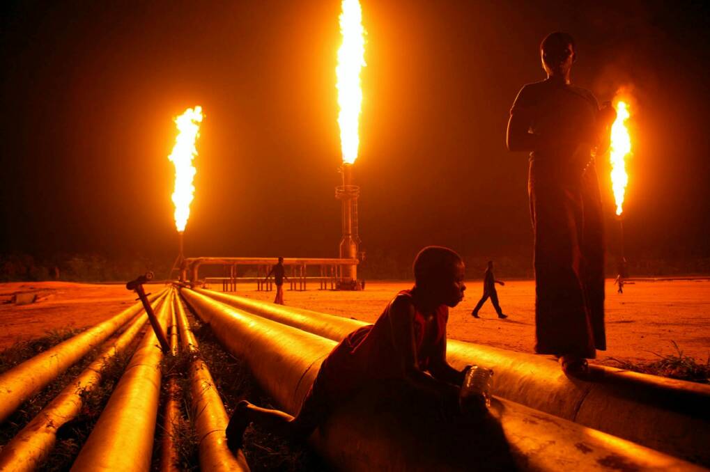 The oil wells of Nigeria light up the sky. Photo: Michael Kamber/New York Times 