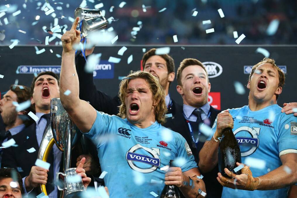 Blue beauties: The Waratahs' Michael Hooper celebrates with teammates after winning the 2014 Super Rugby title. Photo: Getty Images